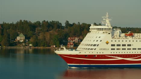 Cineflex-GyroStabilized-tracking,-Aerial-shot,-of-the-Viking-Line-Amorella-passenger-ferry,-passing-the-frame,-in-the-Nordic-lakes,-at-the-baltic-sea,-on-a-sunny,-summer-day