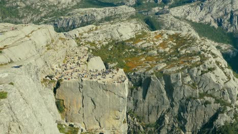 Aerial-high-angle-view-of-cruise-ship-sailing-the-seas-in-Norway's-Lysefjord-at-Pulpit-Rock,-zoom-out-shot,-MV-Boudicca-operated-by-Fred-Olsen-Cruise-Lines