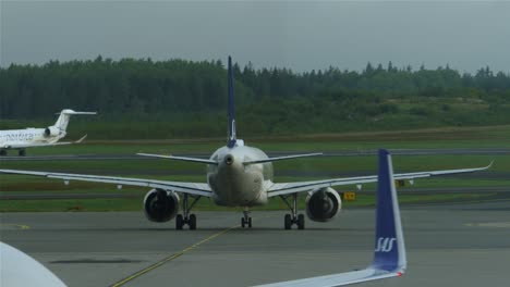 Passenger-aircrafts-moving-on-the-runway-of-Stockholm-airport-in-Sweden-on-a-cloudy-day