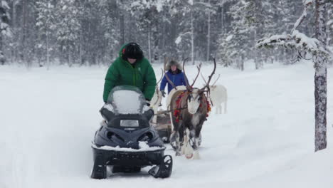 Reindeer-And-Sami-Walking-On-Snowy-Trail