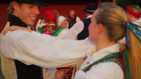 Beautiful-and-graceful-Swedish-folk-dancing-presented-live-on-stage-in-the-tradition-of-celebrating-Midsummer-as-musicians-play-the-violin