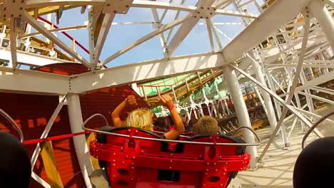 Children-and-enjoy-riding-a-rollercoaster-at-high-speeds-in-an-amusement-park-in-the-summertime