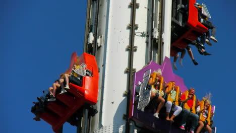 Amusement-park-visited-by-happy-visitors-enjoying-the-outdoor-summer-activities-surrounded-by-many-attractions-and-rides
