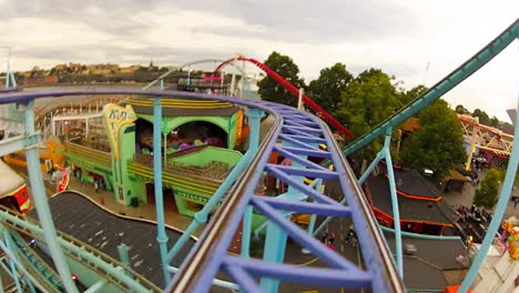 Children-and-enjoy-riding-a-rollercoaster-at-high-speeds-in-an-amusement-park-in-the-summertime