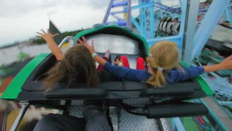 Children-and-enjoy-riding-a-rollercoaster-at-high-speeds-in-an-amusement-park-in-the-summertime