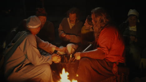 Vikings-socializing-and-interacting-with-each-other-around-a-fire-in-a-clam-and-charming-little-village-in-a-viking-age-village-reenactment-in-Sweden