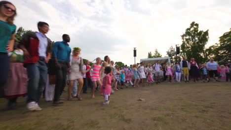 People-of-all-ages-gather-together-and-dance-and-celebrate-the-Midsummer-festival-of-Maypole