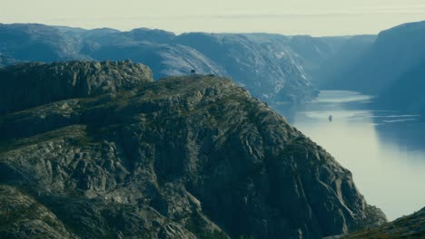 Pulpit-rock-aerial-view-of-people-dangerously-close-to-the-cliff-above-Lysefjord,-part-of-the-Scenic-Ryfylkein-touristic-route