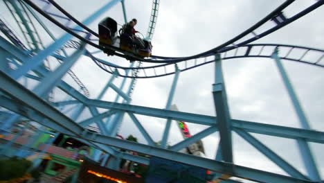 Children-and-enjoy-riding-a-rollercoaster-at-high-speeds-in-an-amusement-park-in-the-summertime