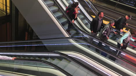 High-angle-view-of-people-going-down-in-a-escalator-in-slow-motion
