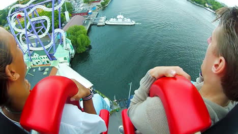 Amusement-park-visited-by-happy-visitors-enjoying-the-outdoor-summer-activities-surrounded-by-many-attractions-and-rides