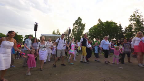 People-of-all-ages-gather-together-and-dance-and-celebrate-the-Midsummer-festival-of-Maypole