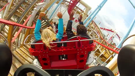 Children-and-enjoy-riding-a-rollercoaster-at-high-speeds-in-an-amusement-park-in-the-summertime
