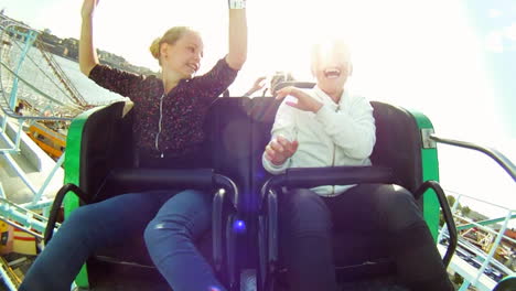 Children-and-enjoy-riding-a-rollercoaster-at-high-speeds-in-an-amusement-park-in-the-summertime