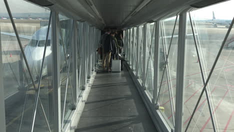 Blick-In-Eine-Jet-Brücke-Mit-Menschen,-Die-Ein-Flugzeug-Besteigen