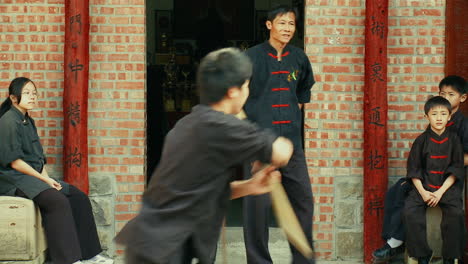 Young-Asian-man-practices-Chinese-martial-art-technique-with-bo-staff