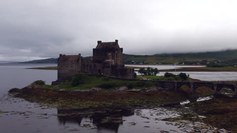 Eilean-Donan-Castle-drone-shot-at-sunset-on-cloudy-moody-day