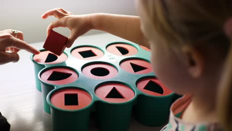 Little-girl-playing-with-baby-sorter-toy