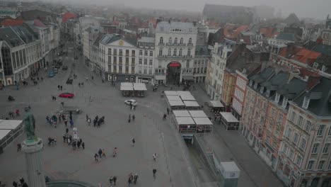 People-passing-Central-town-square-on-a-foggy-day