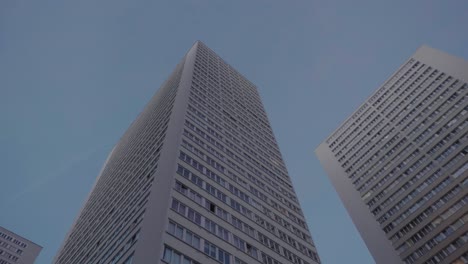 Low-Angle-Looking-Up-At-High-Rise-Tower-Apartments-In-Paris-Against-Blue-Skies