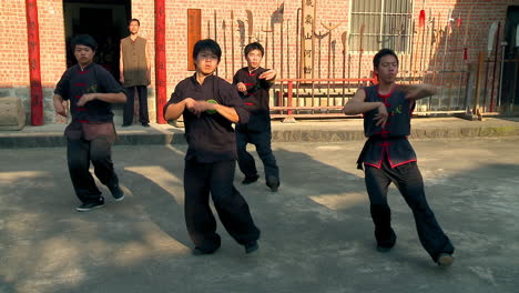 Batch-of-martial-arts-learners-practicing-chop-hit-in-tandem