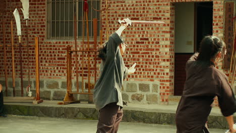 Group-of-young-asian-people-practicing-martial-arts-in-temple