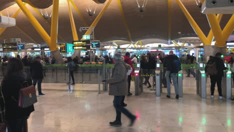 Pan-shot-to-the-left-in-slow-motion-of-people-walking-in-Madrid-airport