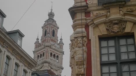 View-of-antique-building-in-Old-Town-Lille-with-Bell-tower-of-Chamber-of-Commerce-in-background