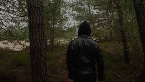 Adult-Hooded-Male-Walking-Through-Forest-At-Fontainebleau,-France