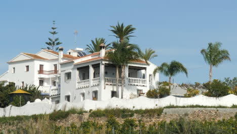 White-Spanish-Style-Villa-Property-on-Sunny-Day,-Track-Parallax