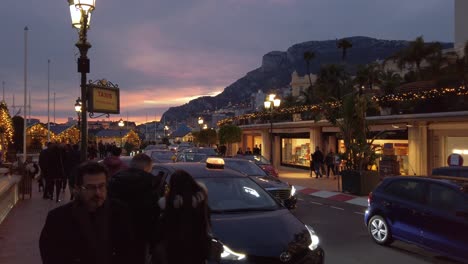 Busy-street-with-many-pedestrians-and-cars-during-sunset-at-Monaco's-Avenue-d'Ostende-in-Monte-Carlo