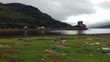 Eilean-Donan-Castle-drone-shot-at-sunset-on-cloudy-moody-day