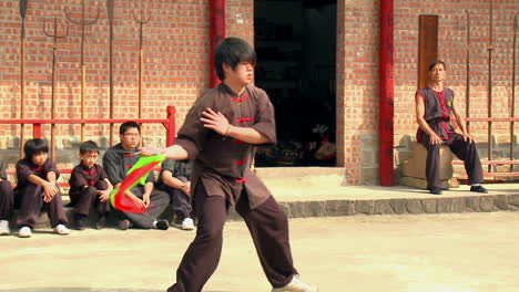 Veteran-martial-arts-artist-practicing-sword-fighting,-follow-shot