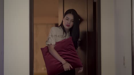 Asiatisches-Mädchen-öffnet-Nachts-Mit-Einem-Schläfrigen-Und-Süßen-Gesichtsausdruck-Die-Tür
