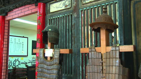 Panning-of-Chinese-armor-and-helmets,-row-soldiers-equipment,-war-museum,-Close-up