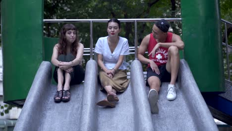 3-young-adults-chatting-in-the-playground