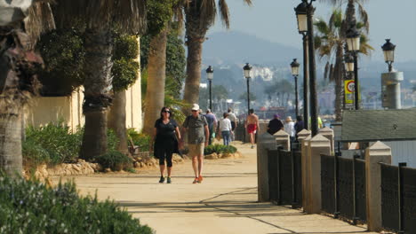 Tourists-Walking-on-Seaside-Boulevard-on-Sunny-Day