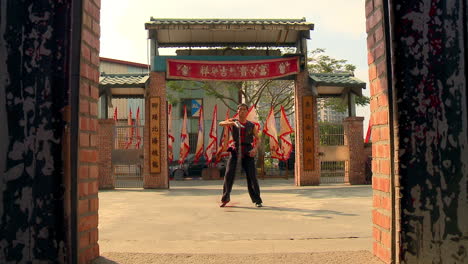 Veteran-chinese-martial-arts-artist-practicing-alone-at-dojo