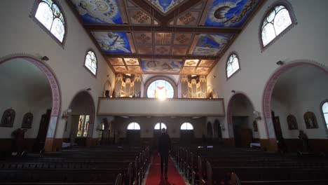 Men-walking-in-church,-back-view