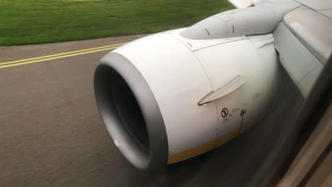 Twin-Jet-Aircraft-Taxiing,-Passenger-view-on-Wing-and-Engine-Tilt-Down