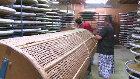 Taiwanese-operator-at-work-with-tea-leaves-drying-machinery-in-Pinglin-factory