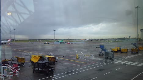 locked-wide-time-lapse-shot-of-Dublin-international-airport-airfield-at-terminal-one-with-many-vehicles-and-Ryanair-Boeing-aircraft-passing-in-foreground-and-background