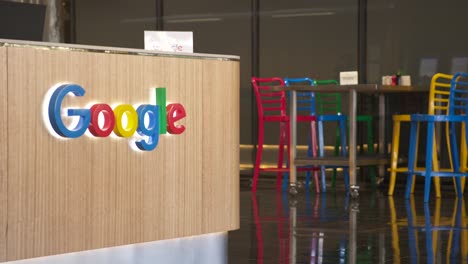 Recepción-De-Google-Con-El-Logotipo-Y-Sillas-De-Colores-De-La-Empresa-Al-Fondo