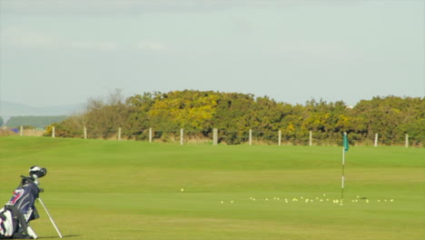 Golfer-wacks-a-ball-at-a-hole-in-slow-motion