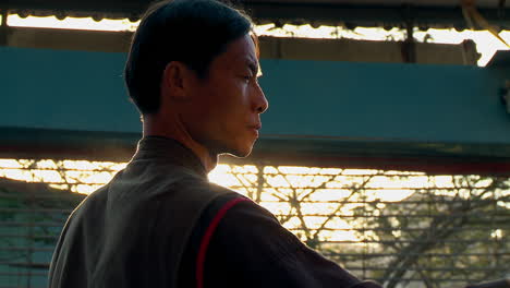 Close-up-shot-of-the-face-of-a-chinese-blacksmith-cleaning-a-sword