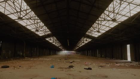 View-Across-Large-Abandoned-Warehouse-With-Rubbish-On-The-Floor