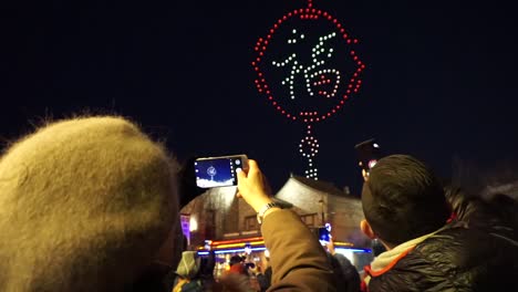 People-recording-a-drone-show-simulating-fireworks