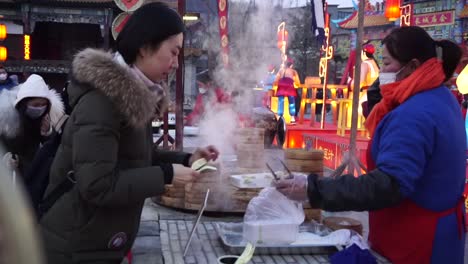 Woman-buying-traditional-food-in-Gubei-Water-Town-before-lockdown-for-Covid19-outbreak