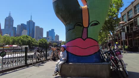 Melbourne-art-sculpture-near-city-centre-with-young-boy-eating-ice-cream