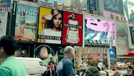 Movies,-plays-and-merchandise-advertised-on-giant-flashing-billboards-surrounding-Times-Square-in-New-York-City